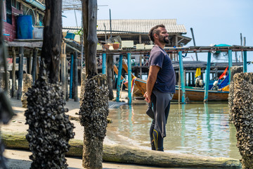 Smiling young man in a wetsuit.