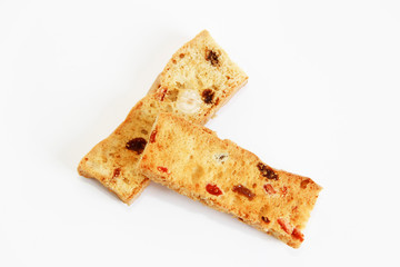 white bread crackers with fruit slices on a white background