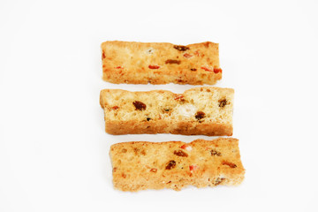 white bread crackers with fruit slices on a white background