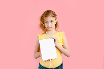 A teenage girl does her homework on a tablet. The student works and communicates with friends. Pink background with free space