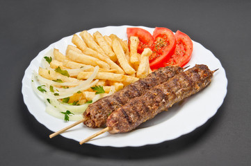 White ceramic plate with food on grey background