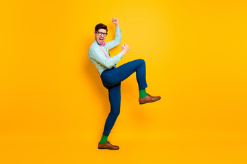 Fototapeta na wymiar Full body profile photo of handsome cool excited guy quarantine finish rise fists ready party festive mood wear specs shirt suspenders bow tie trousers shoes isolated yellow color background