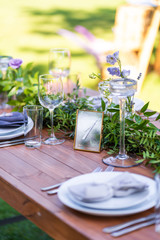 Preparing for an open-air party. Decorated with fresh flowers served tables. Table number. Decoration Details