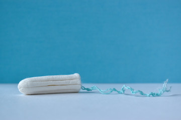 A women's tampon. Menstruation time. Hygiene and security.