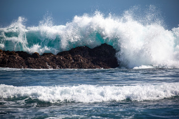 A Fast Shutter Speed Capturing Big Waves Hitting the Rock