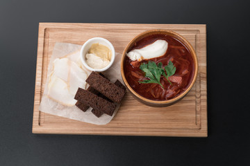 Soup borsch with sour cream and croutons with lard