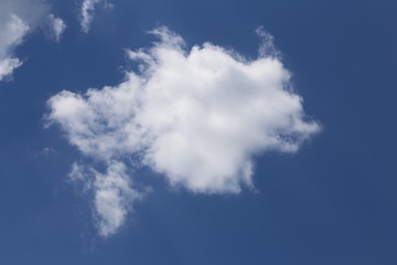 In sunny summer, huge clouds float on the blue sky.