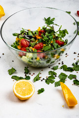 Healthy diet food. Fitness salad from different fresh greens , tomatoes, peppers, avocados, cucumbers with olive oil and balsamic sauce. Close-up.