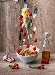 Spaghetti falling into a bowl. Falling food.