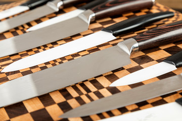 A set of high quality kitchen knives on a cutting board