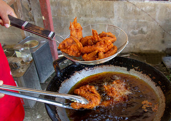 Fried chicken picking up from a frying pan. Tasty, fresh cook and delicious.