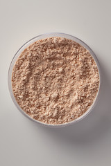 Top View of Cosmetic Powder in Plastic Circular Container.