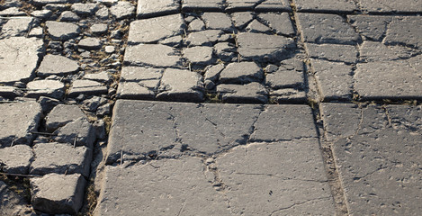 The texture of the broken road. Old building blocks. Background for screensaver monitor