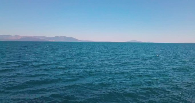 Forward drone shot over the aegean sea and euvoia is visible on the background. 4K video quality, Greece