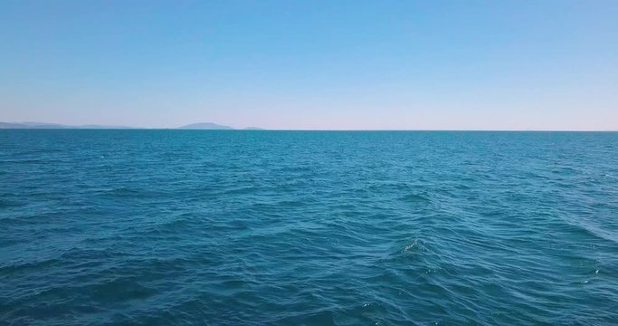 Reveal drone shot of the aegean sea while accelerating over the sea in low altitude. 4K video quality, Greece
