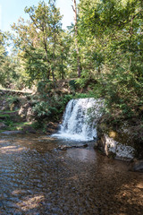 Obraz premium Small waterfall fed by the lake of Saint-Ferreol in South West France