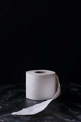 white toilet tissue ,paper on a  black background