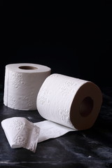 Fototapeta na wymiar white toilet tissue ,paper on a black background