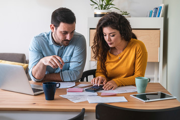 Young couple calculating their domestic bills at home stock photo