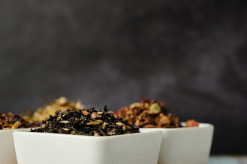 Close up of black tea dry leaves for a detox and healthy infusion drink. Dark background with copy space