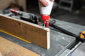 worker glueing wood, carpenter working