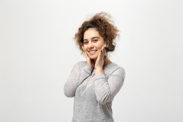Obraz premium Beautiful young woman portrait. Indoor portrait of beautiful brunette young woman with shaggy hairstyle