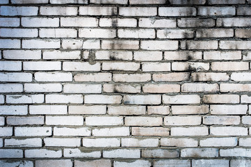 Obraz premium Background of an old, dirty, white brick wall with peeling plaster, painted walls, texture