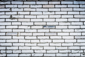 Background of an old, dirty, white brick wall with peeling plaster, painted walls, texture