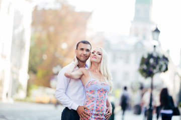 walking down the street together. Happy young man and smiling woman walking through the streets of Old Town,