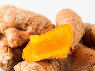 Turmeric root close up on white background