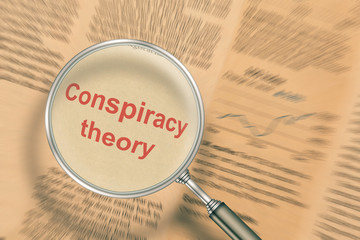 Conspiracy theory. Focus on newspaper news under a magnifying glass
