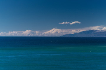 Fototapeta na wymiar The southern coast of Crimea, Balaklava Bay view in windless cloudy weather from the sea.