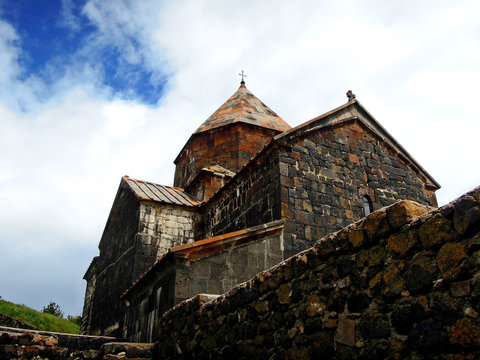 Armenian church Surp Astvatsatsin on cloudy sky background. Complex was founded in 874 AD, built in traditional style. Now it's became important & popular tourist attractions near Yerevan, Armeni
