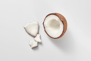 Top view of fresh natural organic coconut's half on a light grey background.