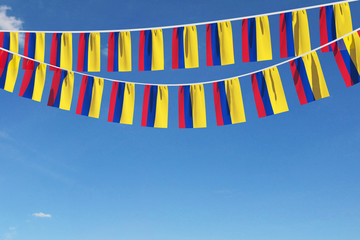 Colombia flag festive bunting hanging against a blue sky. 3D Render