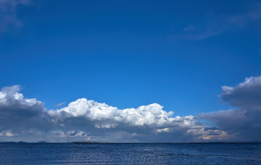Obraz premium Blue sky with clouds over sea.