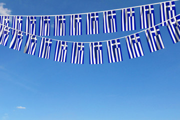 Greece flag festive bunting hanging against a blue sky. 3D Render © ink drop
