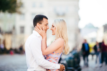 walking down the street together. Happy young man and smiling woman walking through the streets of Old Town,