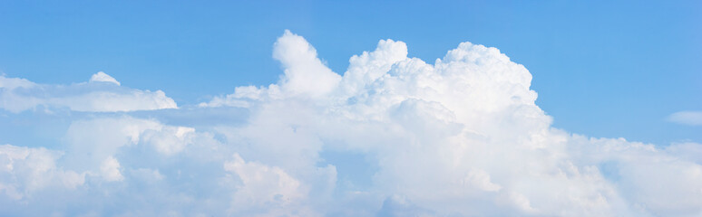Naklejka na ściany i meble In sunny summer, huge clouds float on sky. Nature weather.