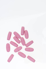 Pills spilling out of pill bottle. Assorted pharmaceutical medicine pills, tablets and capsules on white background. Antiretrovirals on white background.