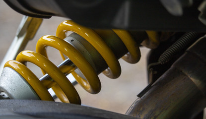 Motorcycle shock absorber with yellow coil spring on the rear wheel