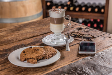 coffee with milk with cookie note and cell phone glasses 