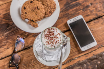 coffee with milk with cookie note and cell phone glasses 