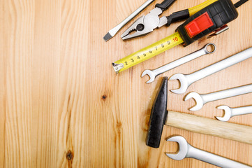 A set of tools on a wooden table top with space for text