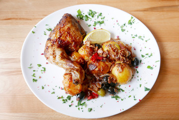 Cooked meal with chicken, lemon and potatoes
