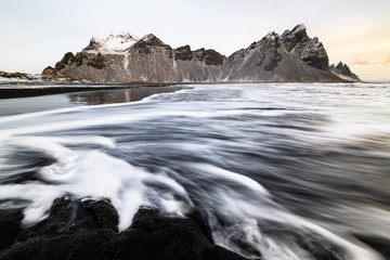 Waves at Stokksnes black beach during scenic sunrise 