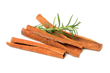  Cinnamon and rosemary on a white background