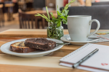 white cup with pudding notepad and pen in bar