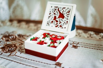 Gold wedding rings on a background of flowers. Wedding ring for the bride and groom on their wedding day. A pair of wedding rings.