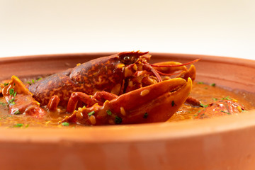 Lobster stew in a clay pot dish. Caldereta de bogavante